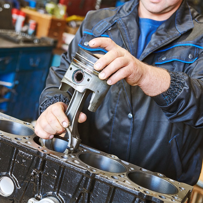Man repairing a diesel engine