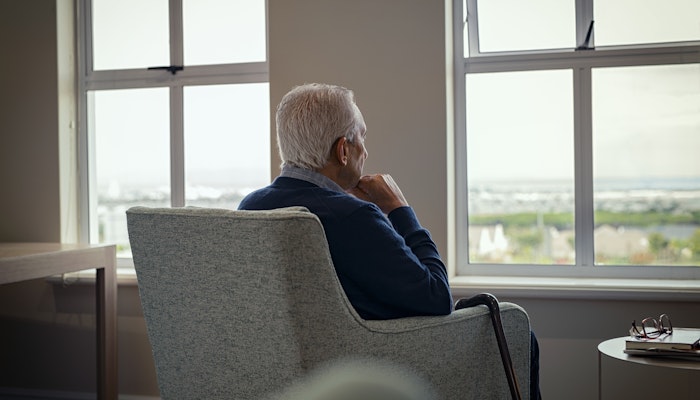 Old man looking out a window
