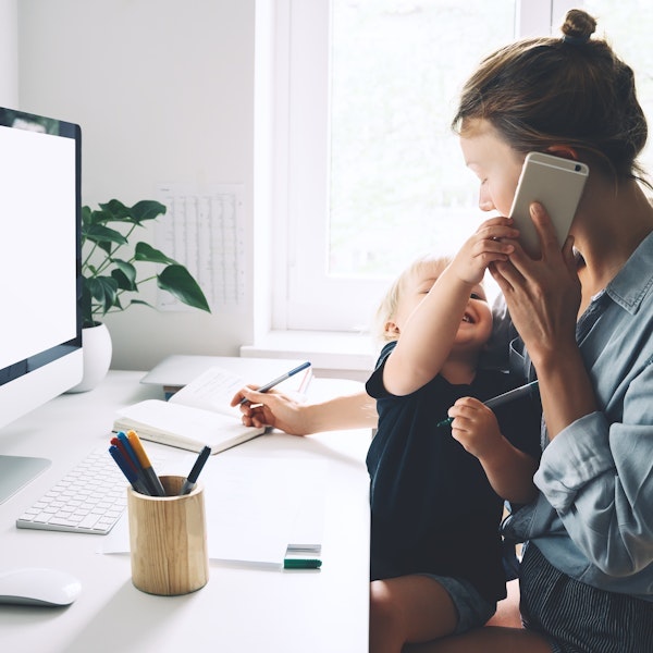woman working from home with her baby in her lap