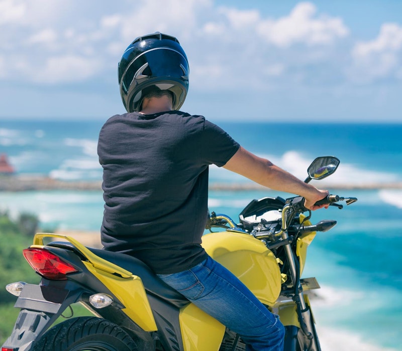 Motorcycle rider looking at the ocean