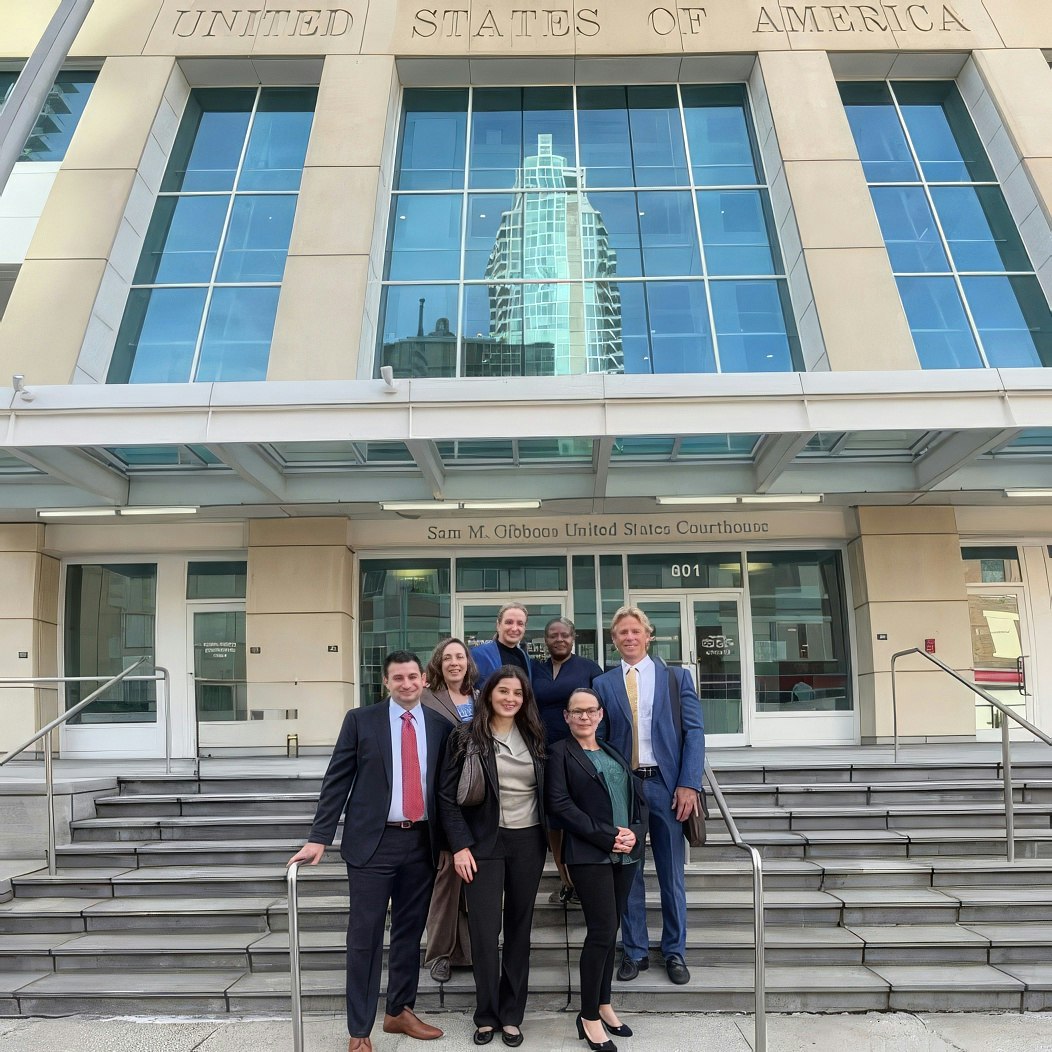 Legal team and client on courthouse steps