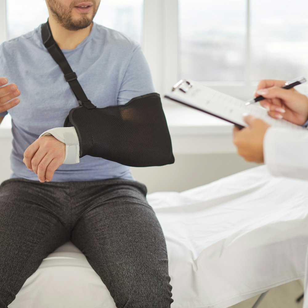 Man in hospital with arm in sling