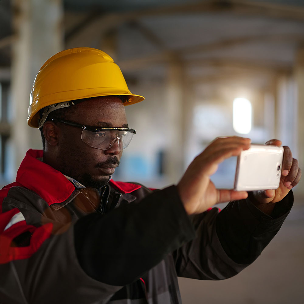 Construction worker taking photos