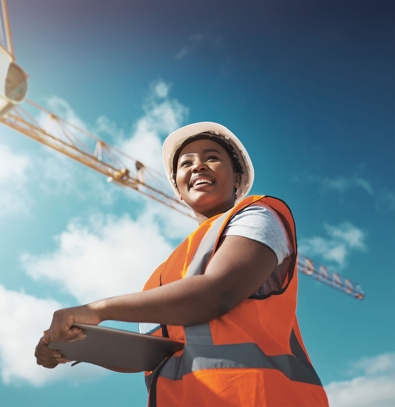 woman smiling below crane