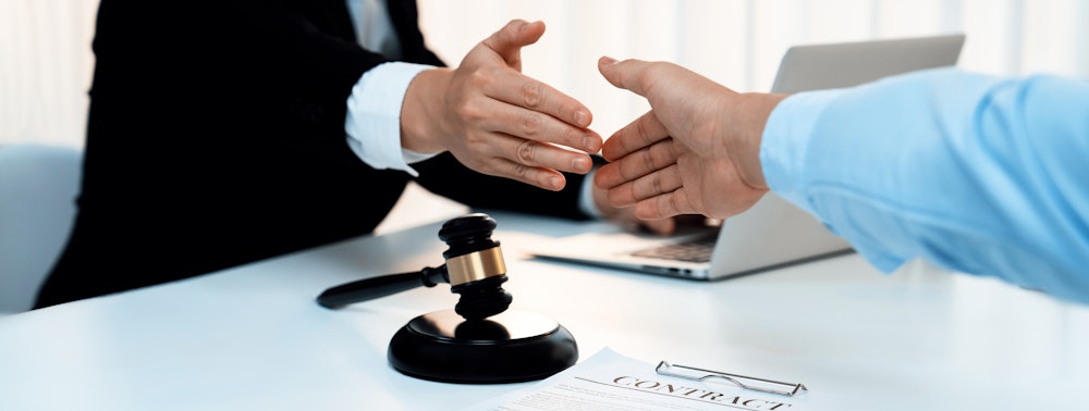 handshake over gavel