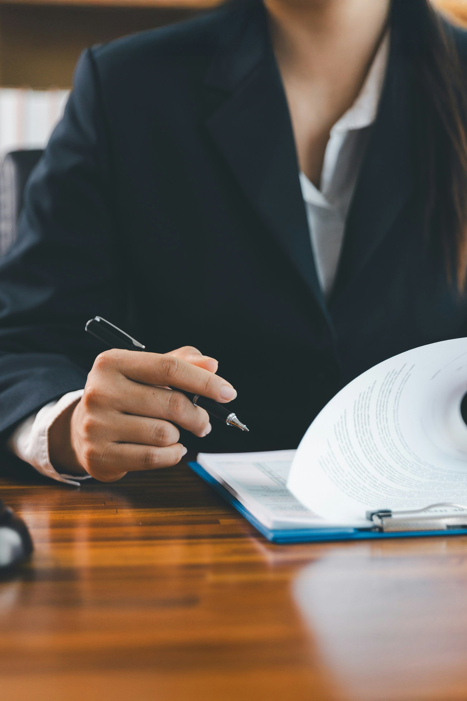 Woman signing paperwork