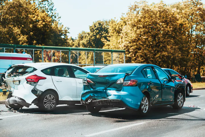 Two compact cars damaged in a collision