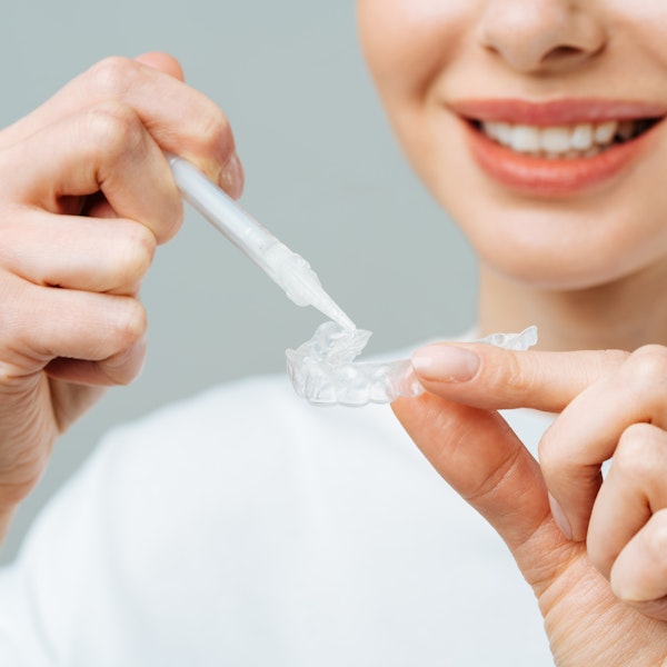 Woman filling whitening tray