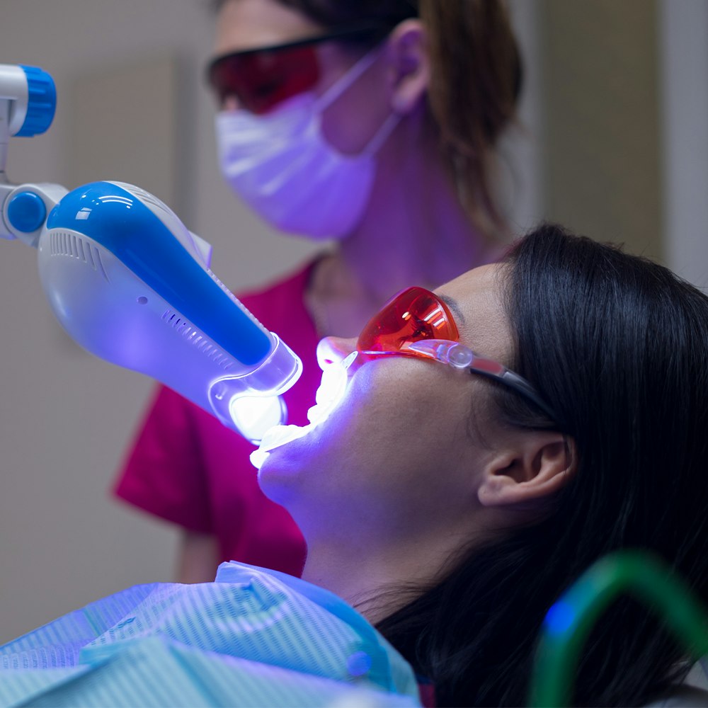 Woman receiving teeth whitening treatment