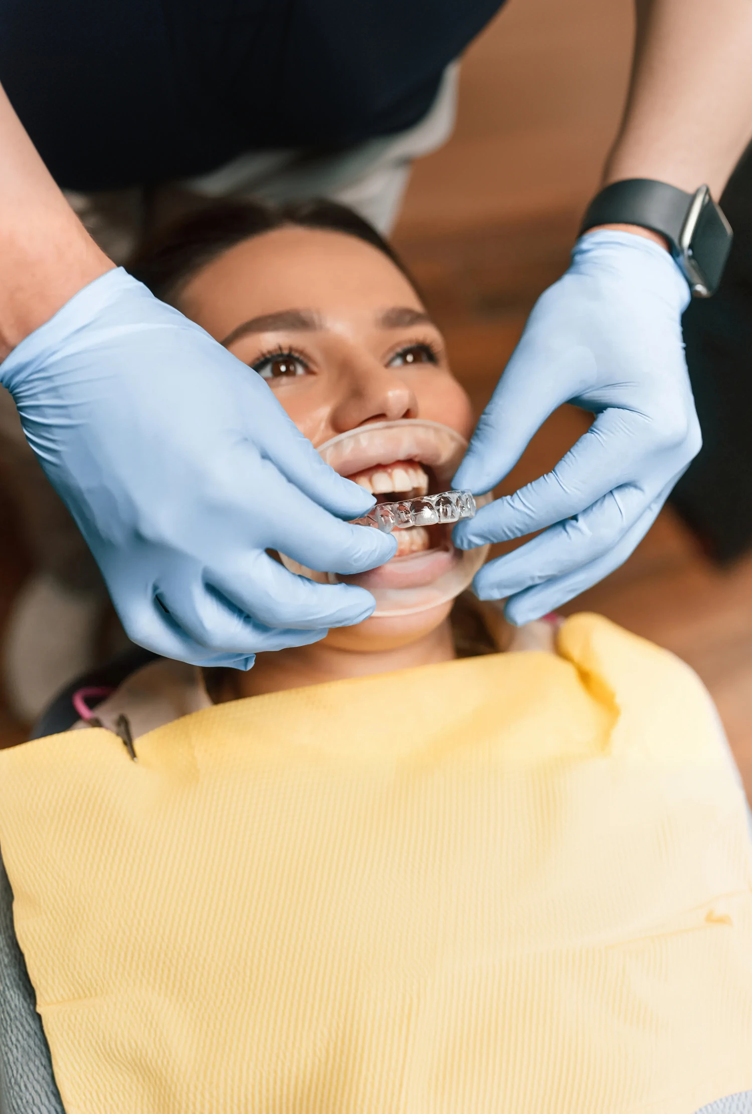 Doctor putting Invisalign on patient