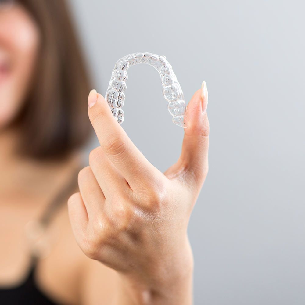 Close up of woman holding Invisalign