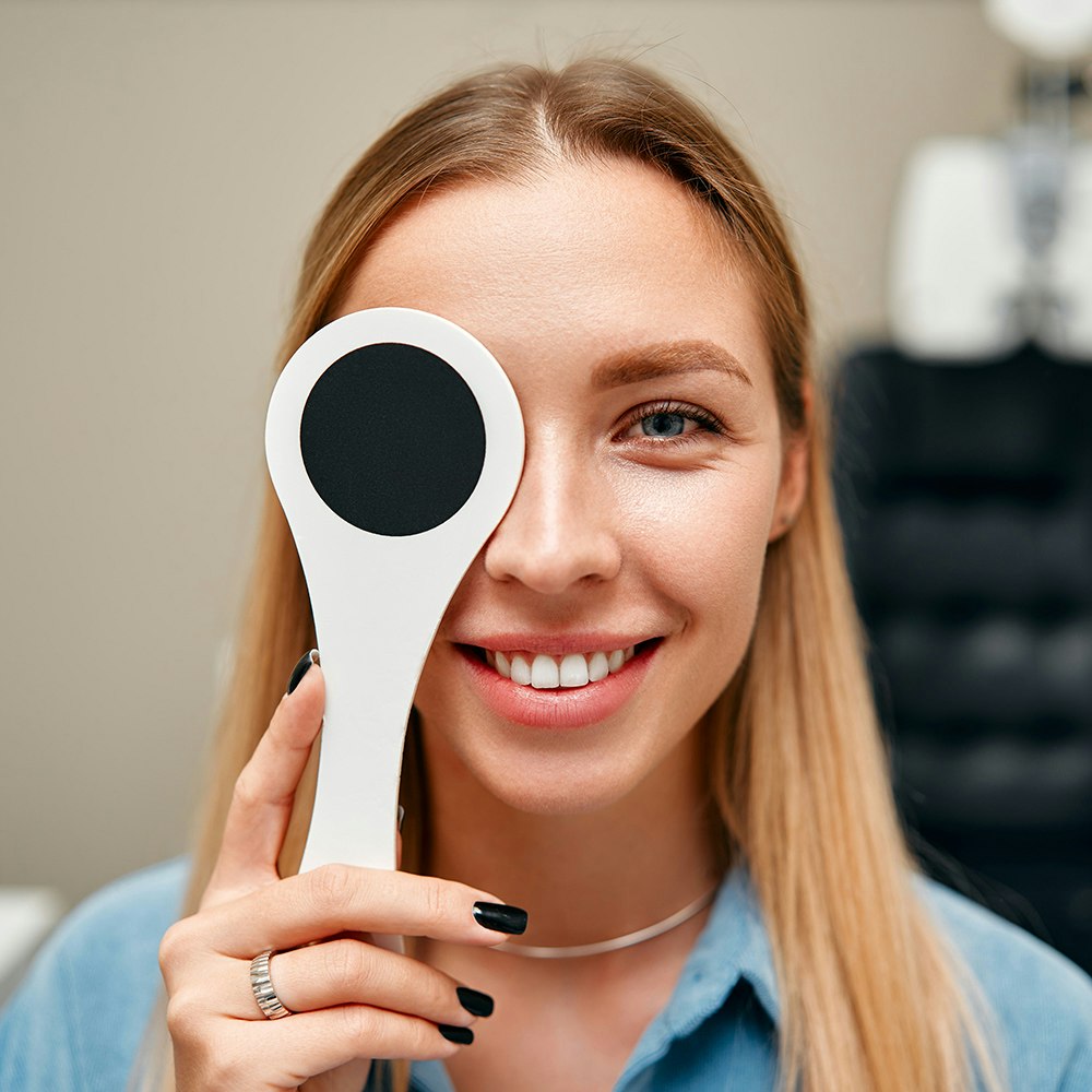 woman covering one eye