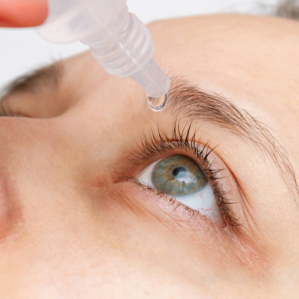 a person getting eye drops in their eye