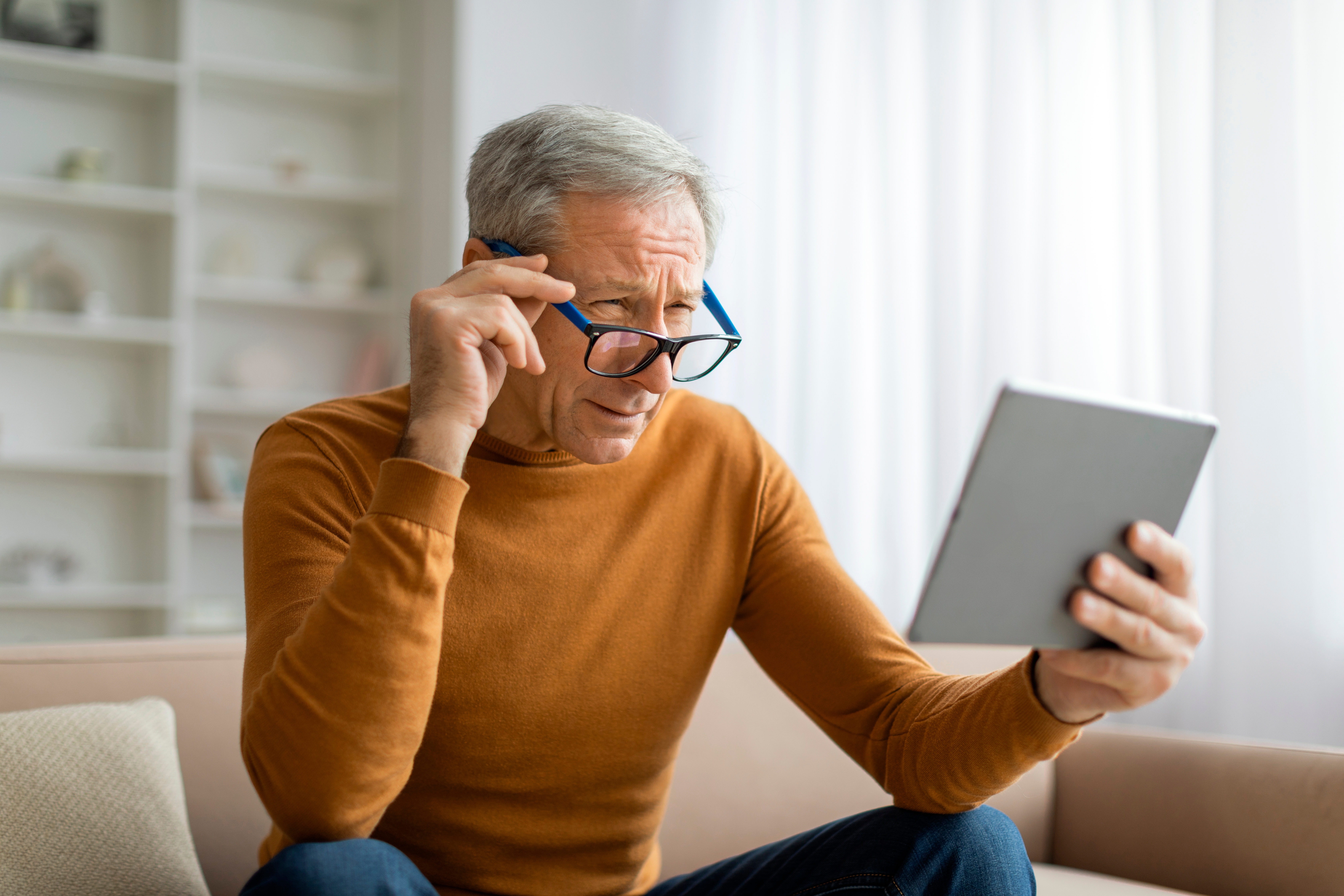 Mature man struggling from presbyopia