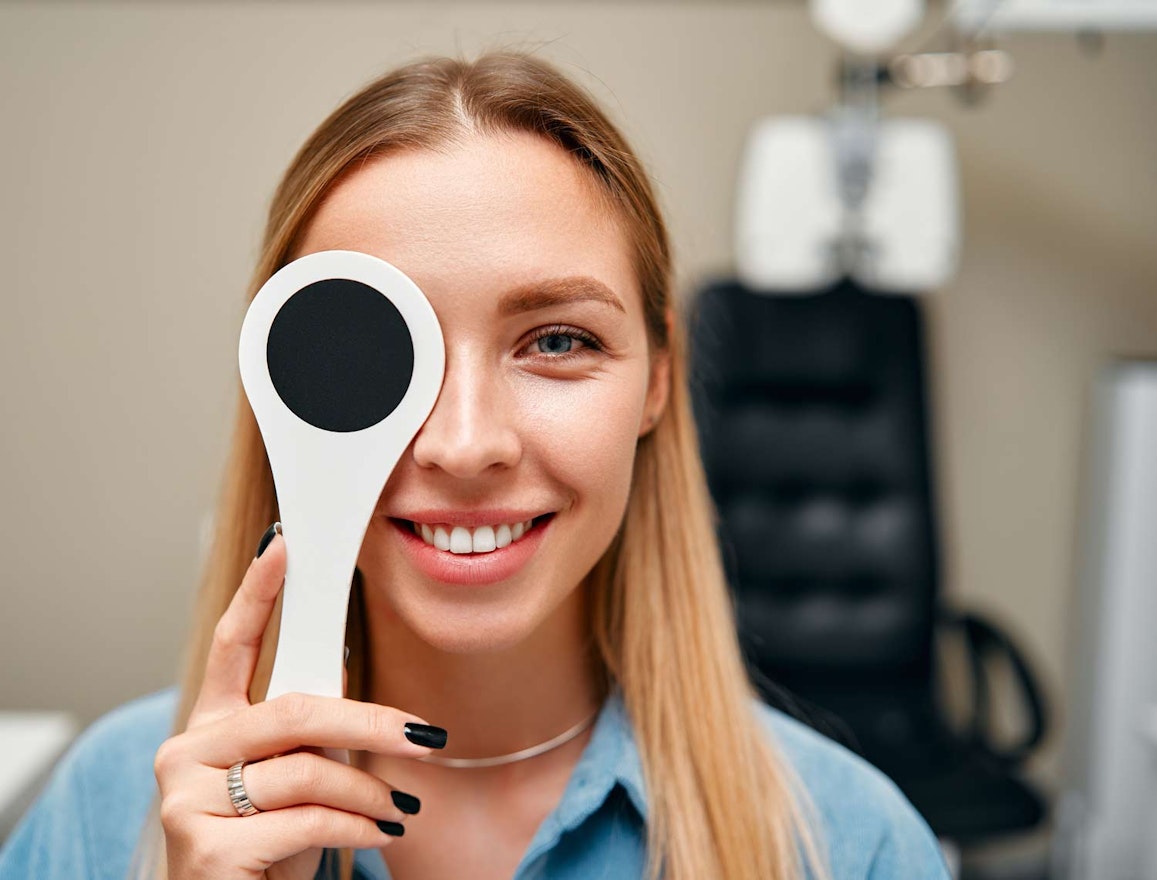 Cute young woman taking eye test