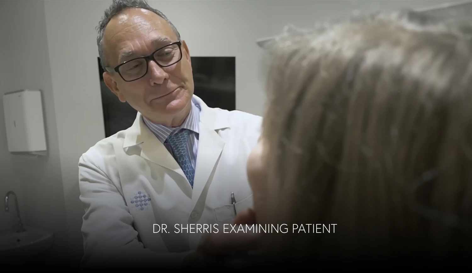 Dr. Sherris examining a patient