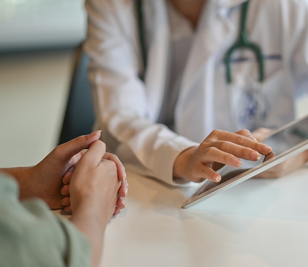 Medical professional speaking with patient