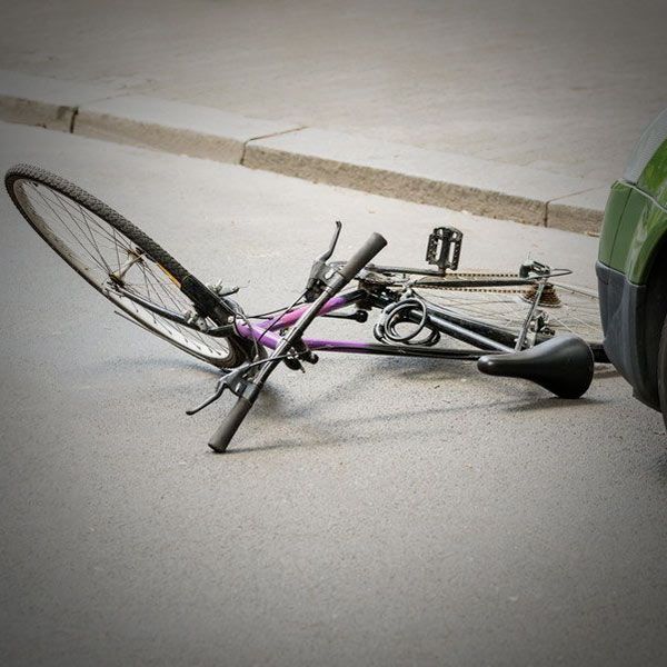 Bike down in front of car