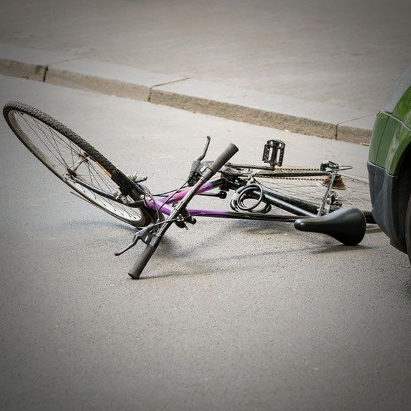 Bike down in front of car