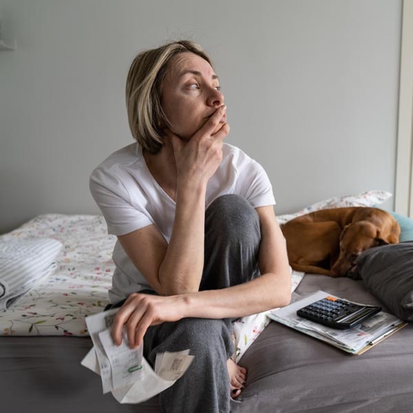 stressed woman with pile of bills