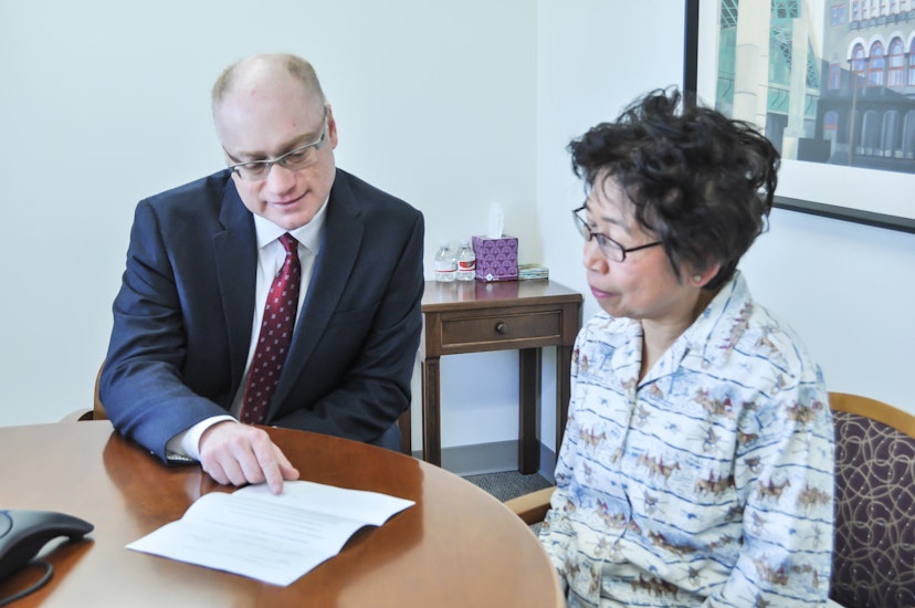 Josh Silverman reviewing documents with a client