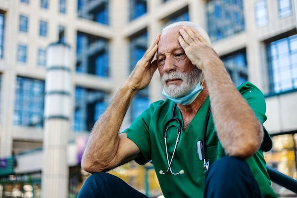 Doctor hanging his head in sadness