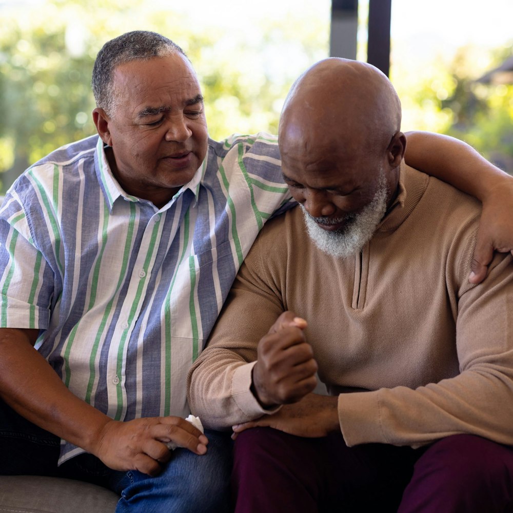 Man with his arm around an older man