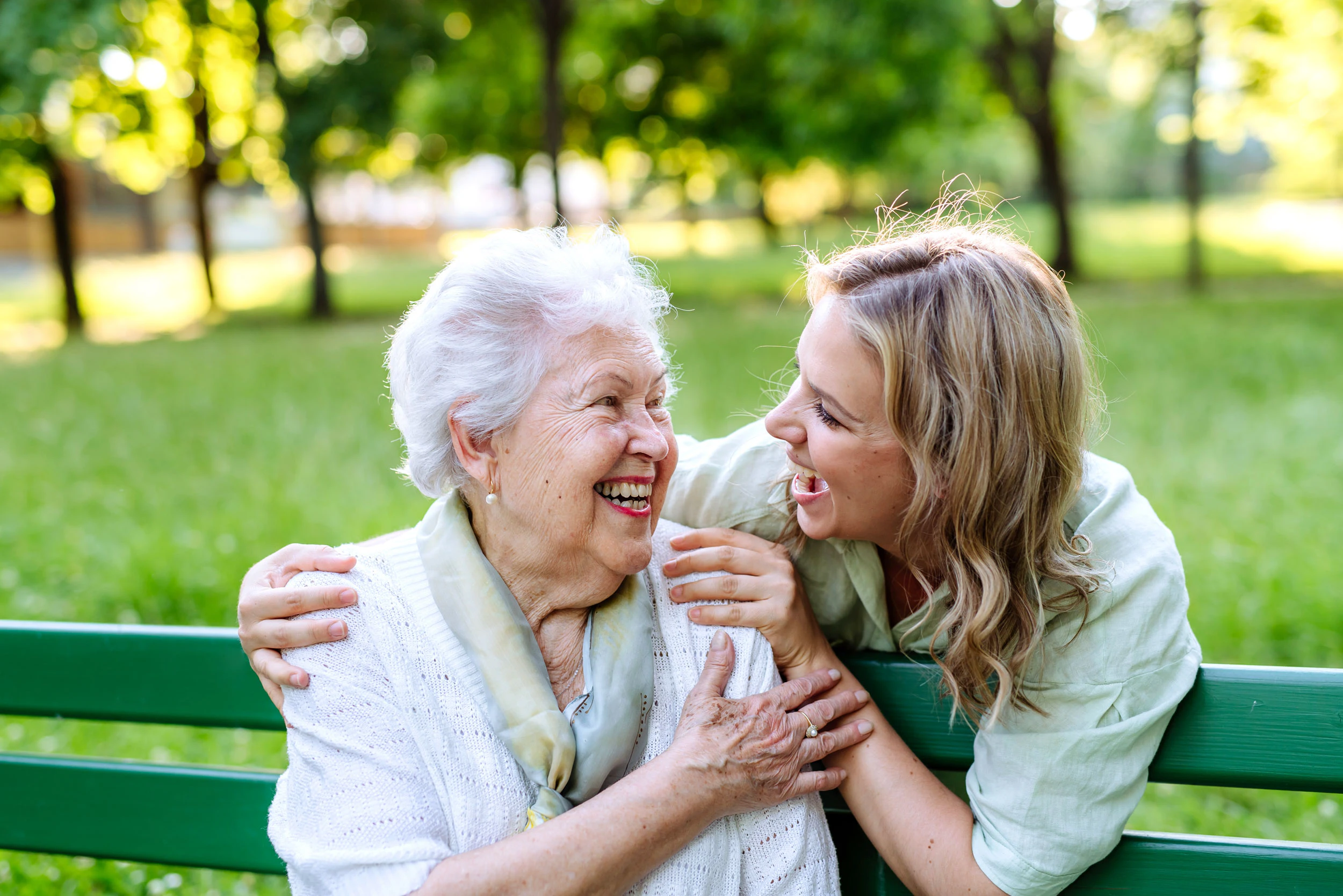 mother and daughter on park bench