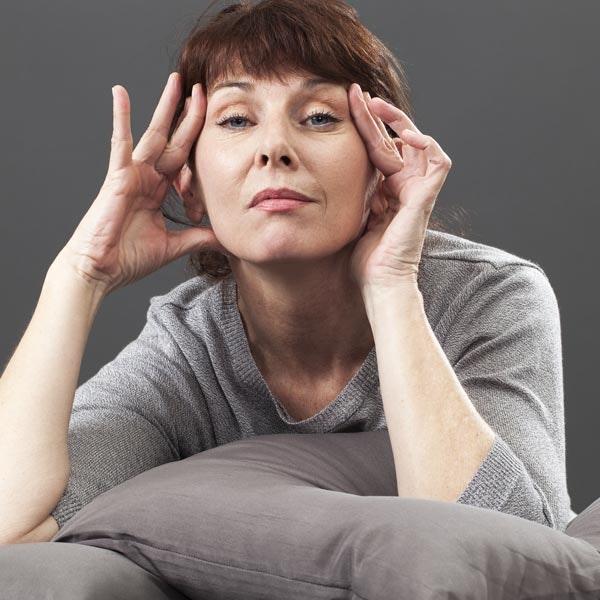 Woman lifting facial skin with fingers