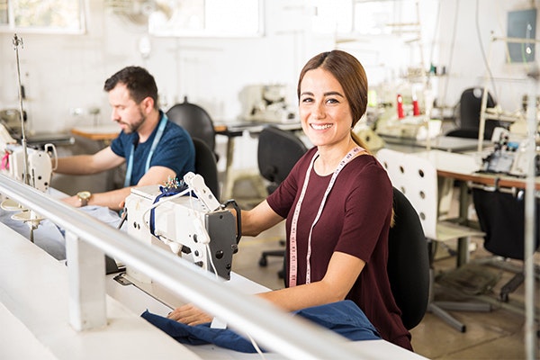 Smiling woman at sewing machine