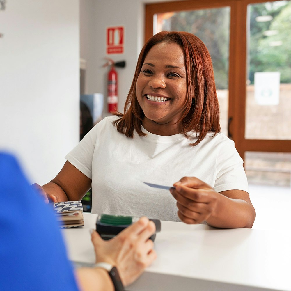 a woman paying the dentist