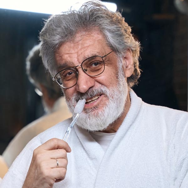 Mature man brushing teeth