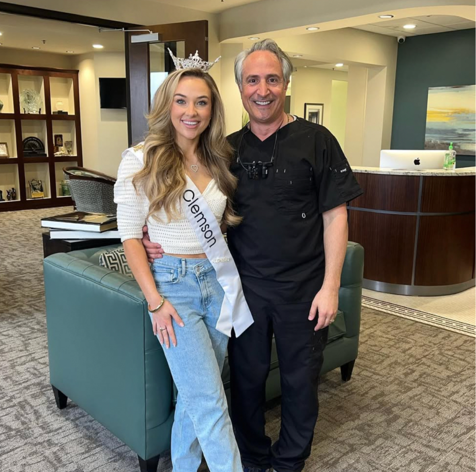 Dr. Nick smiling with a pageant winner