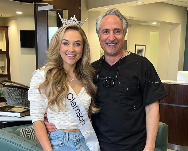 Dr. Nick smiling with pageant winner