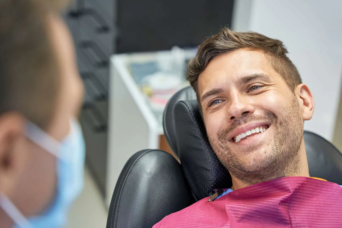 smiling man in dentist