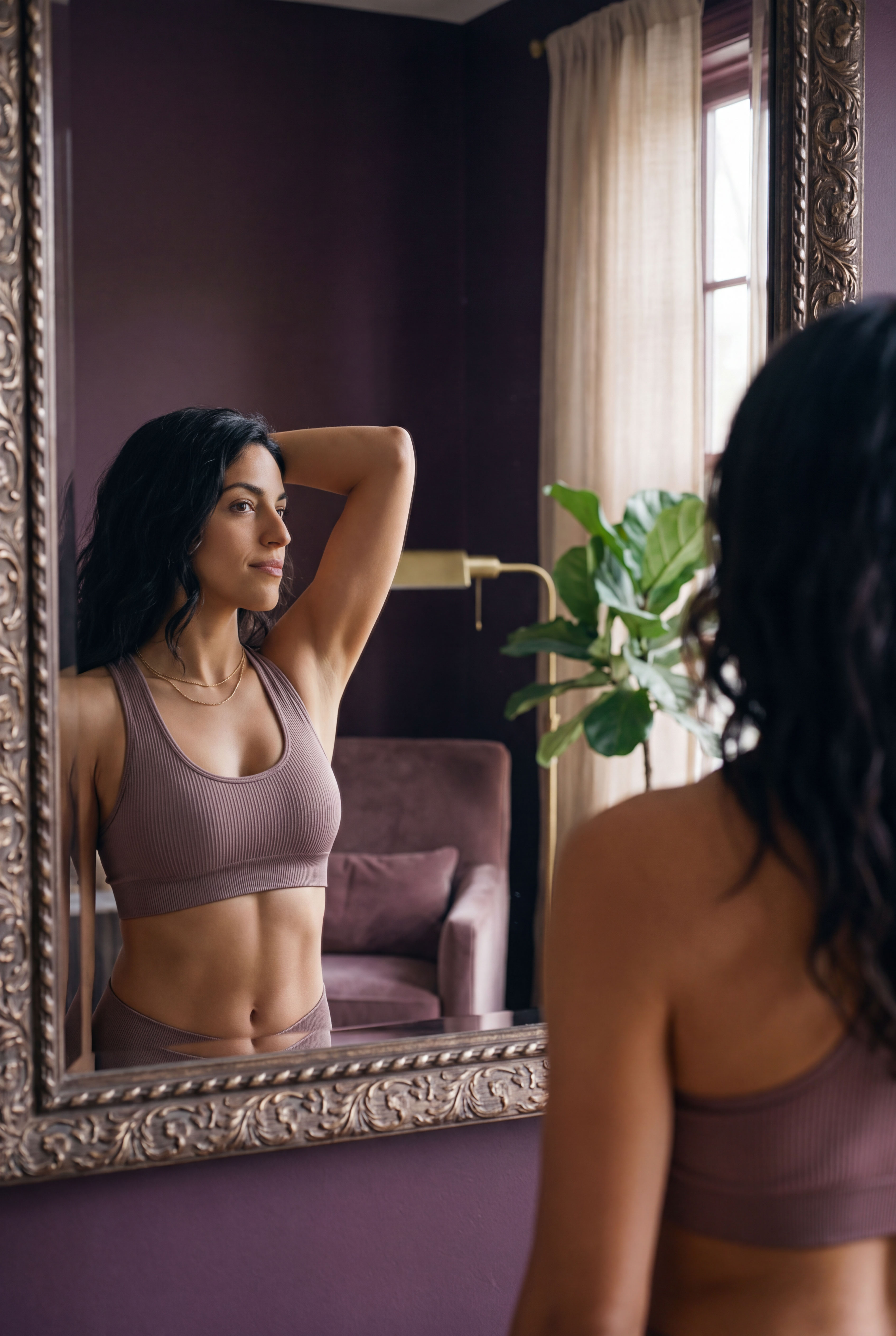 woman admires her bustline in the mirror
