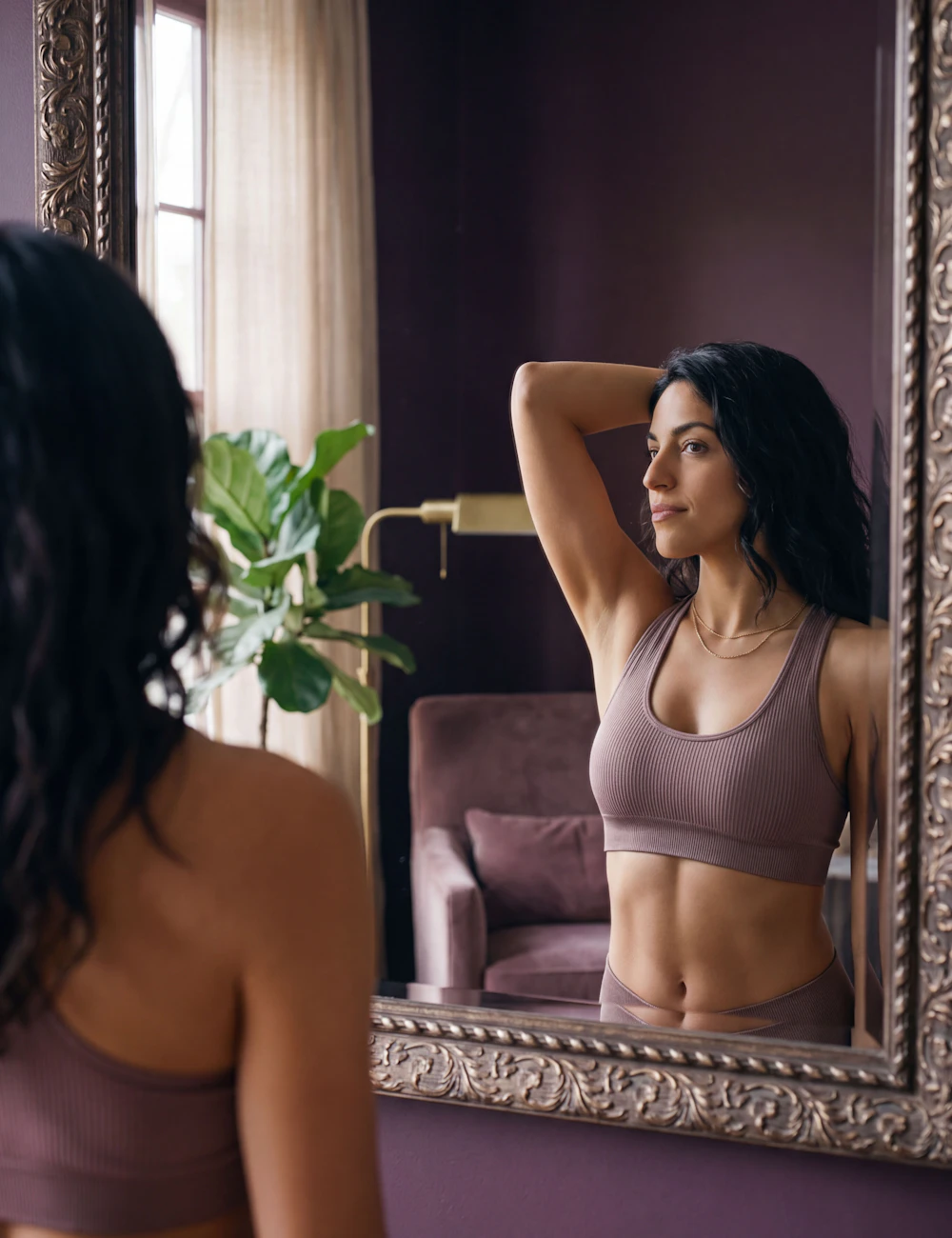 woman admires her bustline in the mirror