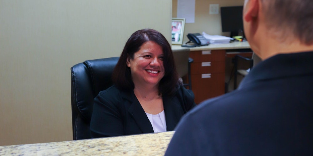 Receptionist smiling at root canal patient