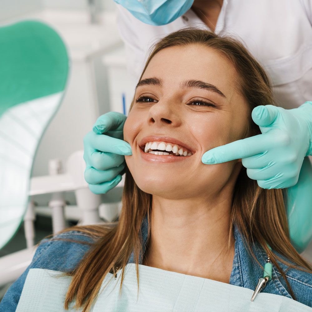 Dental patient smiling into mirror