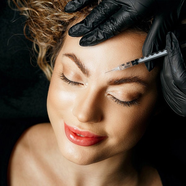 Smiling woman receiving injection