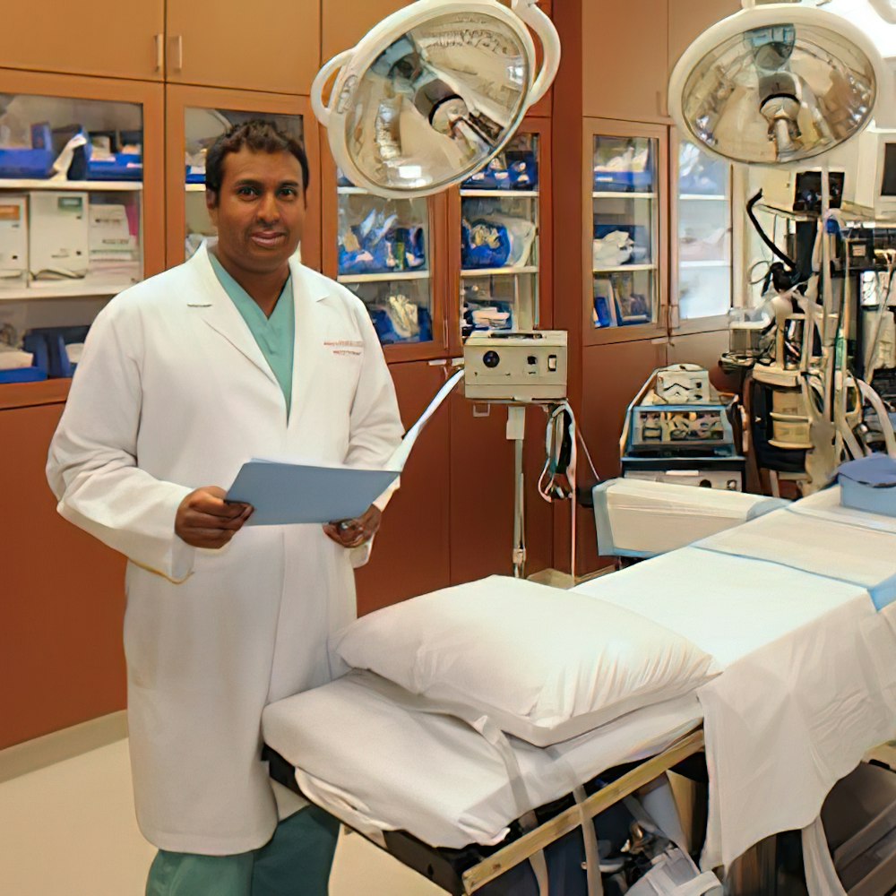 Dr. Ramalla next to a surgery bed