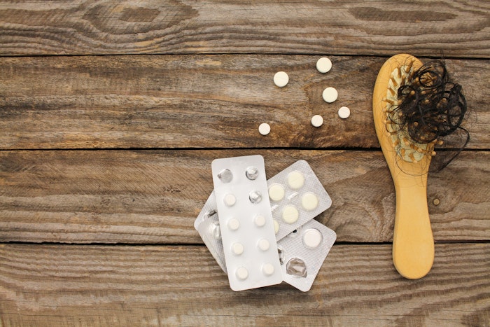 Brush with hair in it and prescription pills