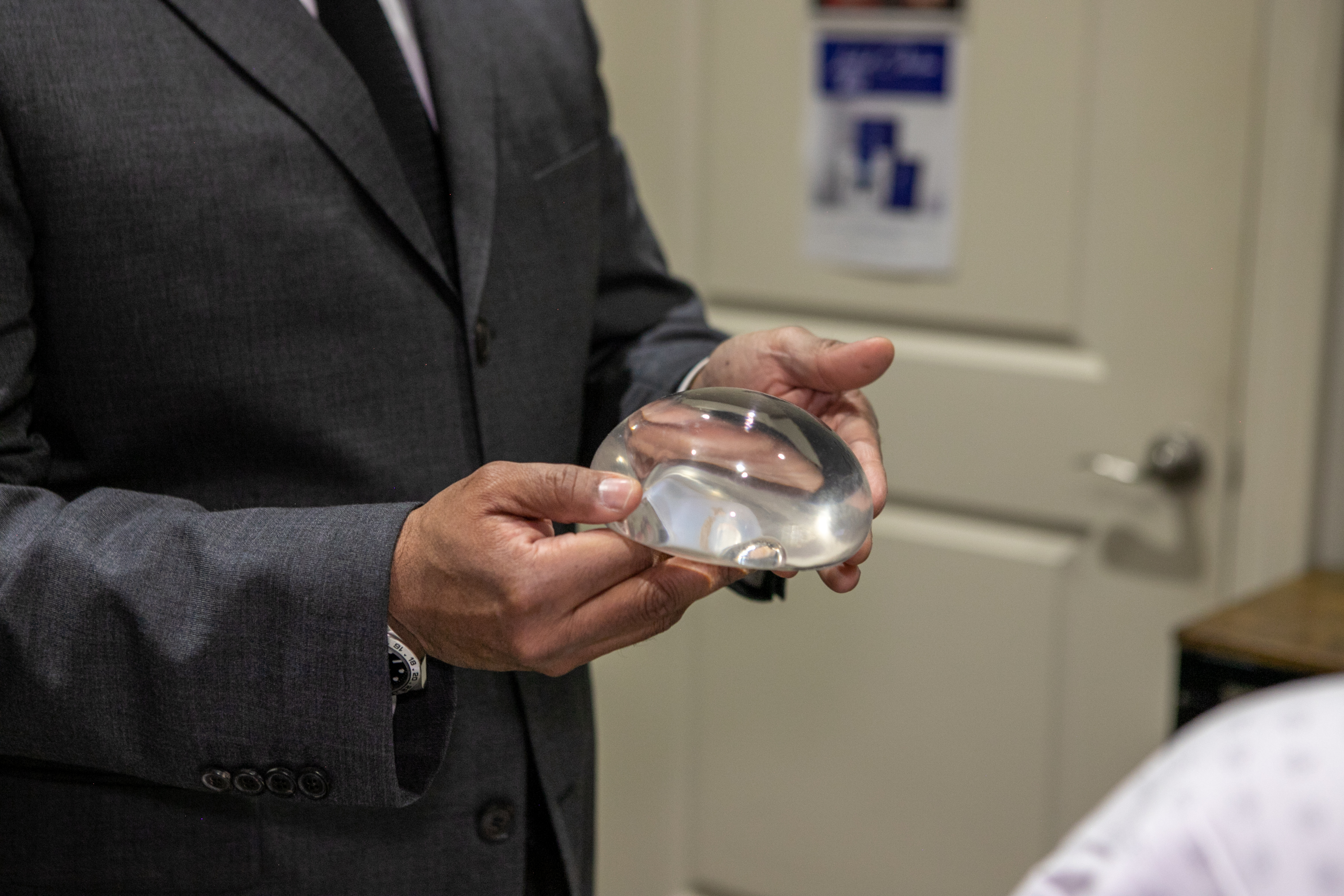 Dr. Rumalla displaying a breast implant