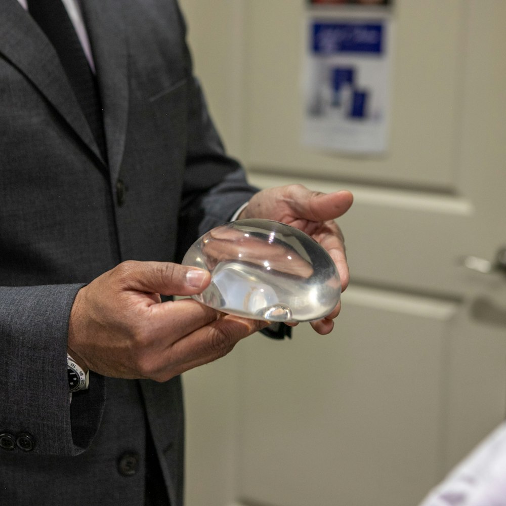 Dr. Rumalla displaying a breast implant