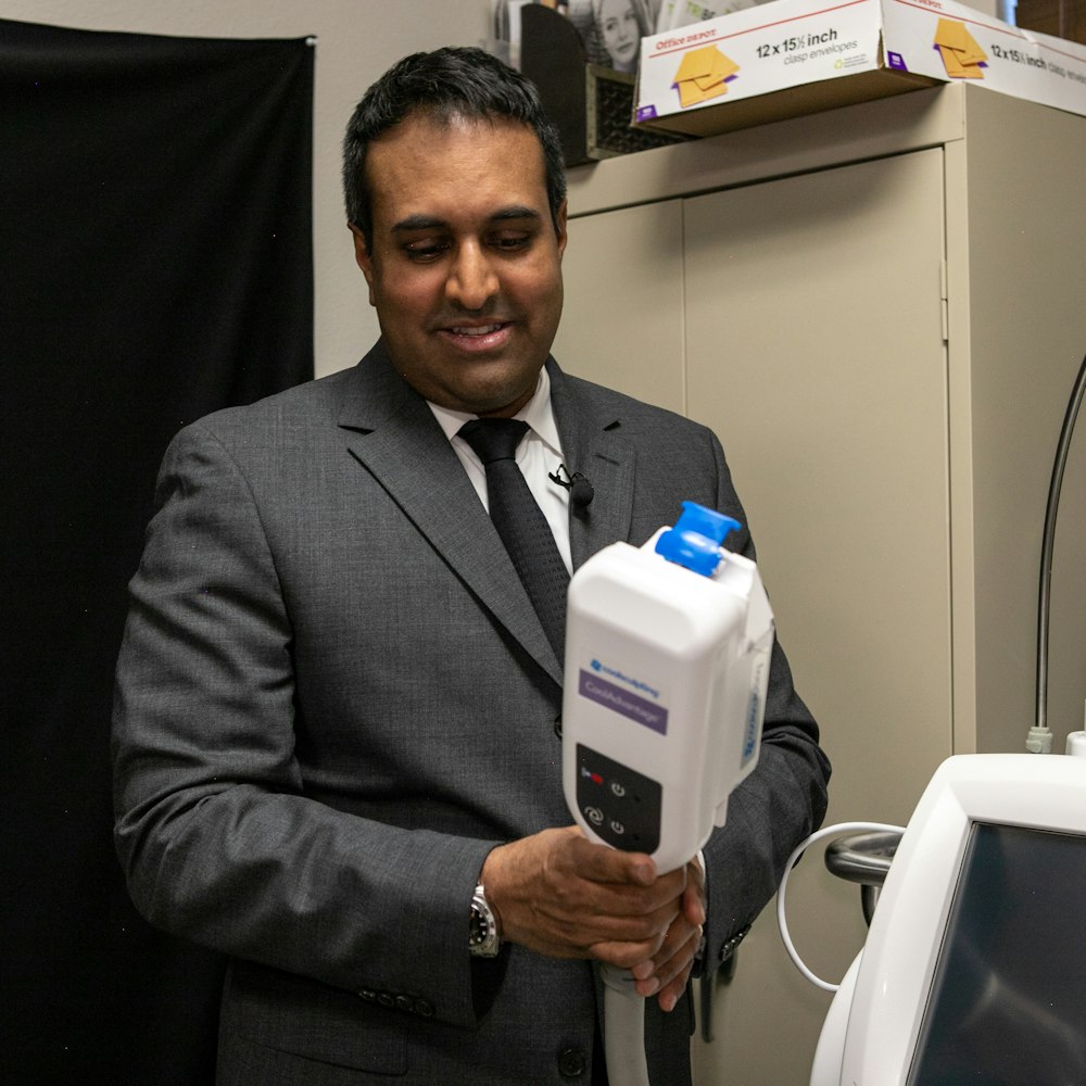 Dr. Rumalla showing body contouring system