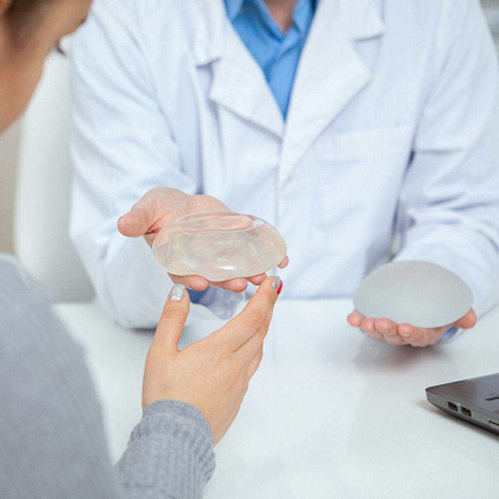 Doctor showing patient implant options