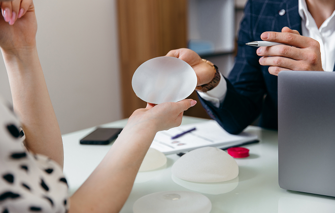 Doctor showing patient a saline implant