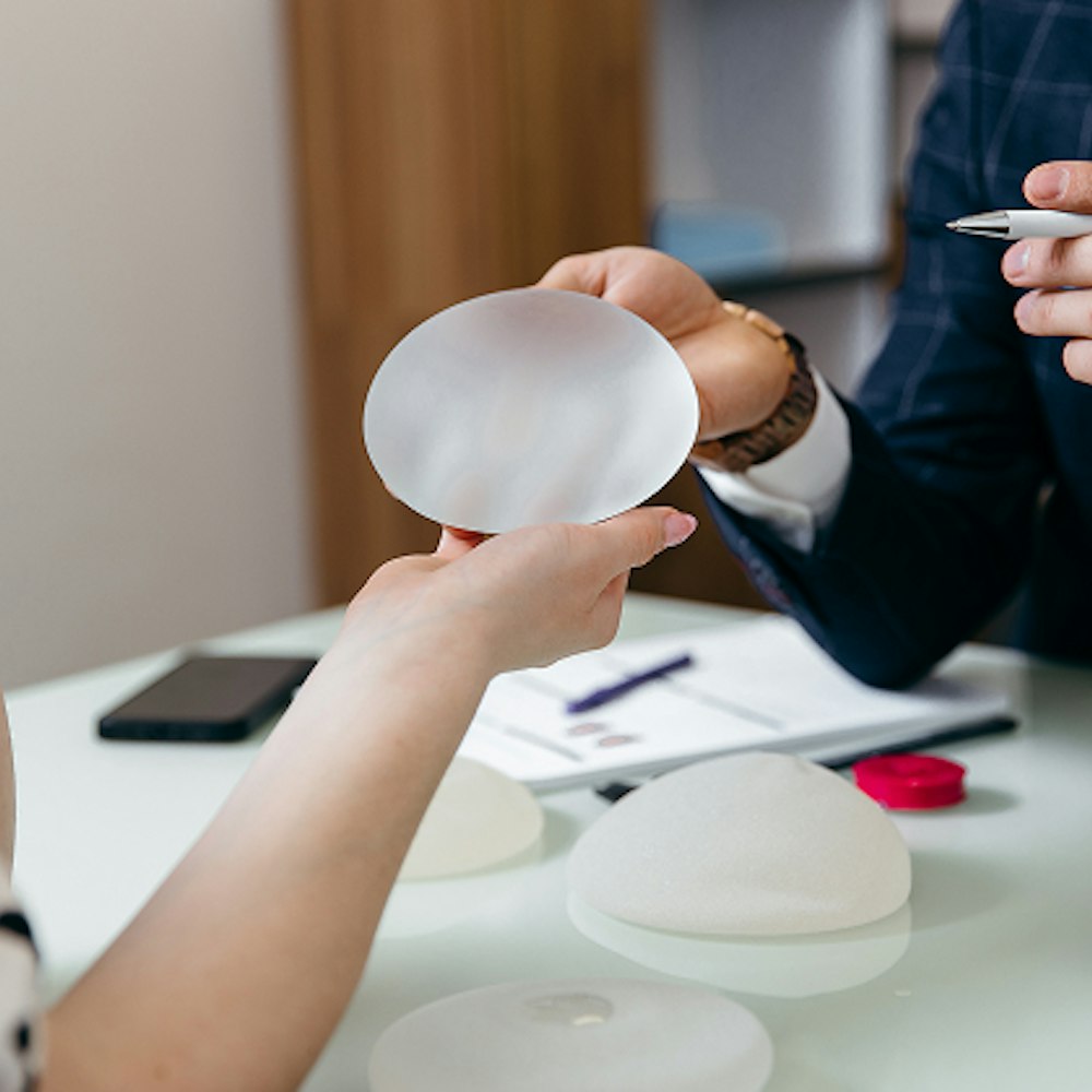 Doctor showing patient a saline implant