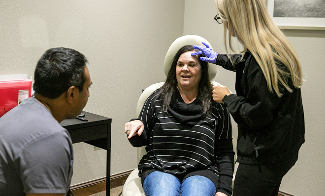 Dr. Rumalla and staff with patient