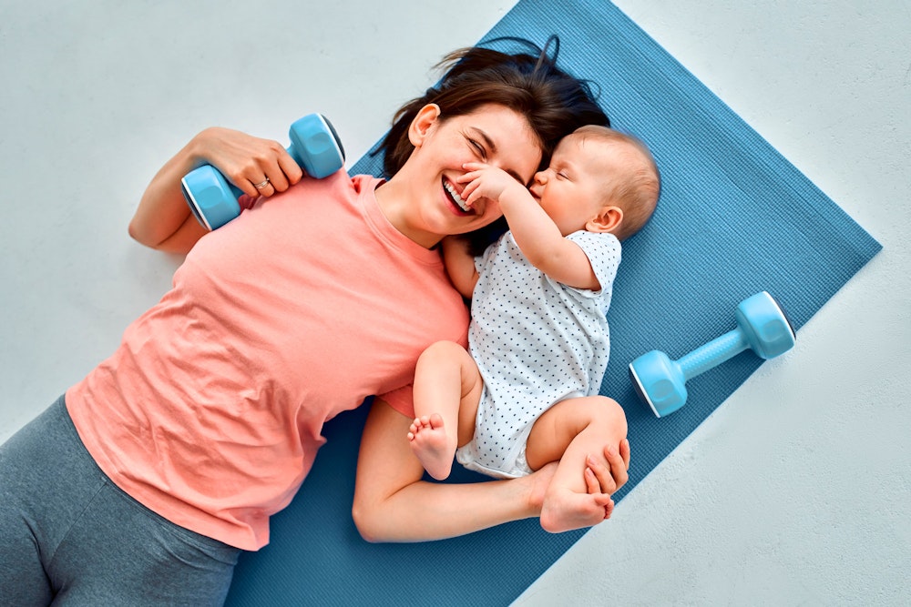 mom on yoga mat with baby